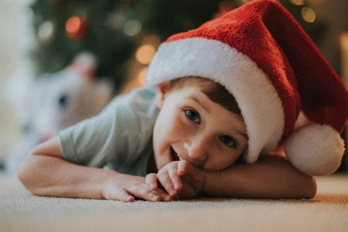 boy with a big grin, celebrating a happy Christmas - Australian Stock Image