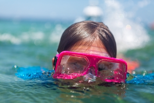 Boy with Snorkel Goggles in clean blue water - Australian Stock Image