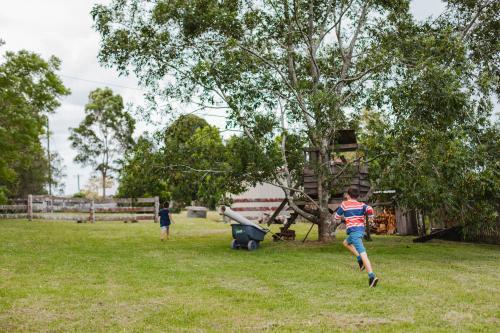 Boys running on farm - Australian Stock Image