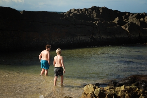 Boys swimming at The Tanks rocky tourist attraction at Forster, NSW Australia - Australian Stock Image