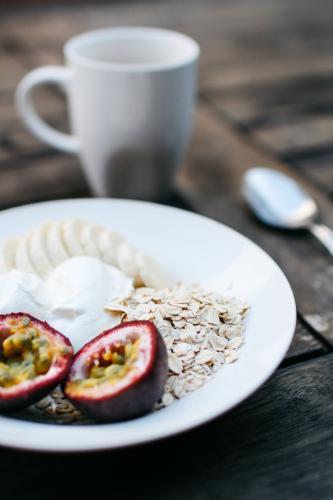 Breakfast Detail with Fruit and Yoghurt on Table - Australian Stock Image