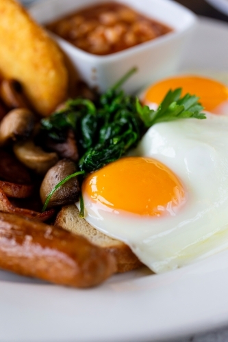 Breakfast dish with fried egg and sausage - Australian Stock Image
