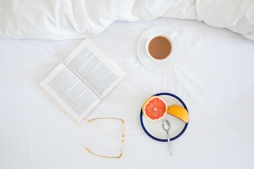 Breakfast flatlay on white bedspread - Australian Stock Image