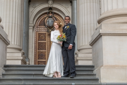 Bridal photos couple together on stairs - Australian Stock Image