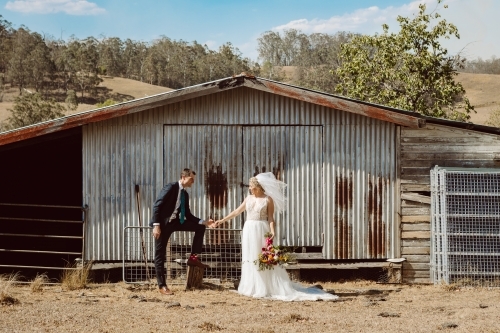 Bride and Groom in front of old shed