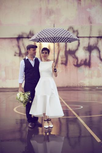 Bride and groom posing under an umbrella - Australian Stock Image