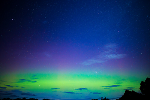 brilliant green aurora shimmering in night sky - Australian Stock Image