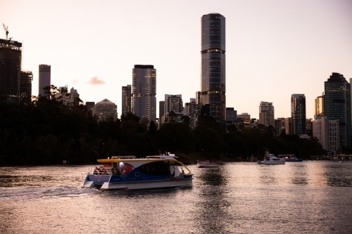 Brisbane city ferry on the river at dusk