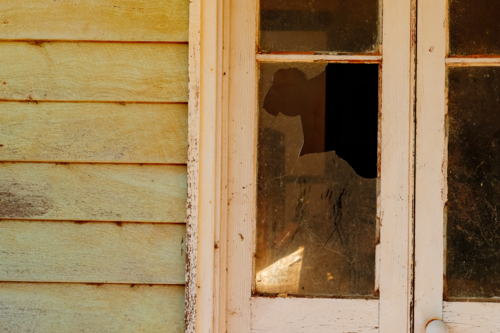 Broken window in a old abandoned house - Australian Stock Image