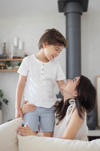 Brother and sister on couch at home together - Australian Stock Image
