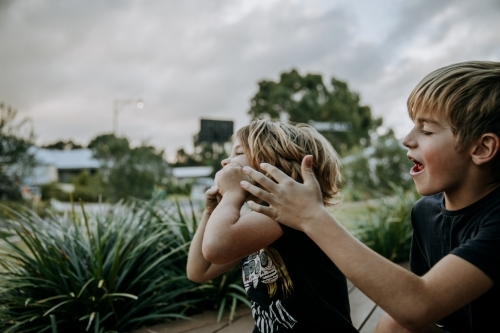 Brothers learning to blow bubbles - Australian Stock Image