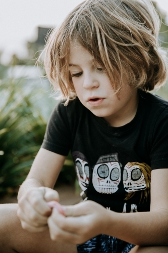 Boy learning to blow bubbles - Australian Stock Image