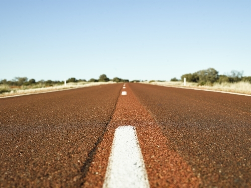 brown bitumen highway in outback - Australian Stock Image