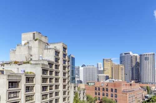 Brutalist apartments with city skyline behind - Australian Stock Image