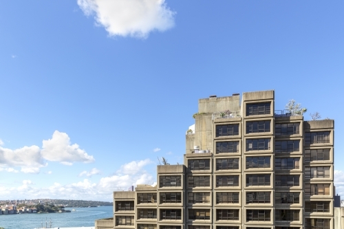 Brutalist apartments with harbour in the background - Australian Stock Image