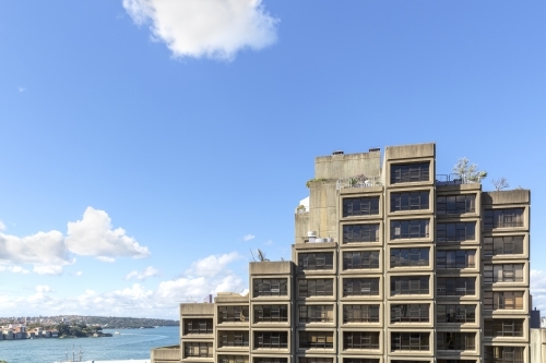 Brutalist apartments with harbour in the background
