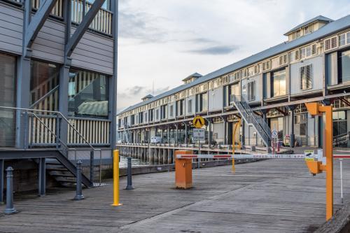 Walsh Bay wharves in Sydney showing historic timber structures along the waterfront - Australian Stock Image