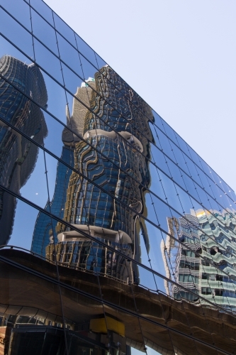 Buildings reflected in modern glass facade