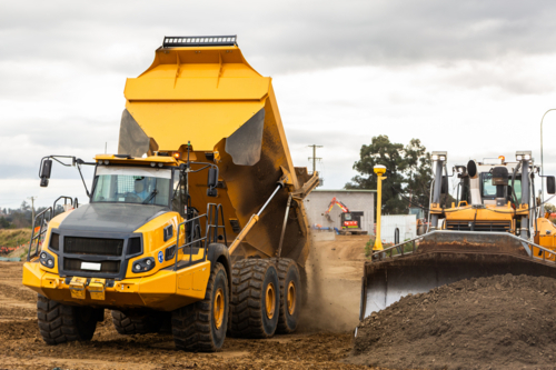bulldozer and dump truck on construction site with earthworks building Singleton bypass - Australian Stock Image