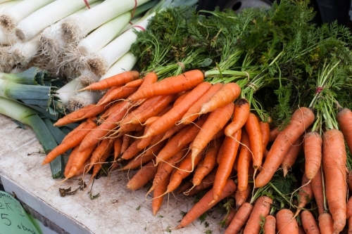 Bunches of organic carrots and leeks at a regional market - Australian Stock Image