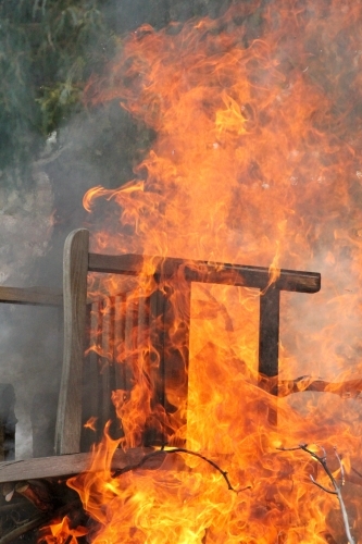 Burning chair on bonfire - Australian Stock Image