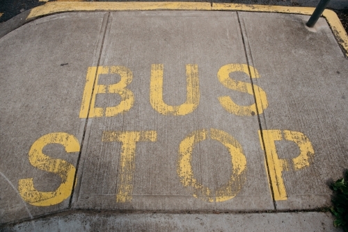 Bus Stop sign painted on pavement - Australian Stock Image