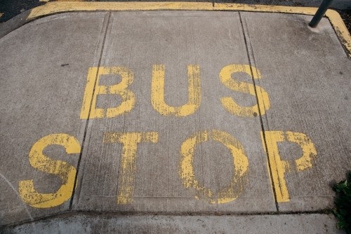 Bus Stop sign painted on pavement