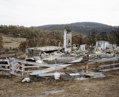 Bushfire ravaged landscape with destroyed country house