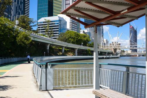 Business man in distance wallking along shared riverside pedestrian bikeway - Australian Stock Image
