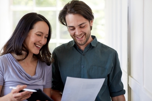 Business woman and man discussing work near paned glass window - Australian Stock Image