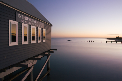 Busselton Jetty shimmers in the early morning in light - Australian Stock Image