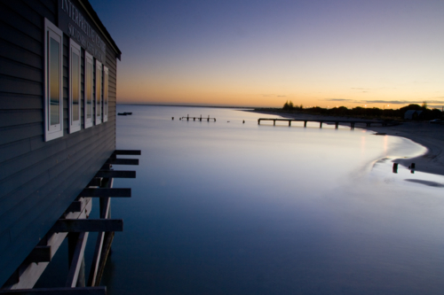 Busselton Jetty shimmers in the early morning in light in Busselton, Western Australia, Australia - Australian Stock Image