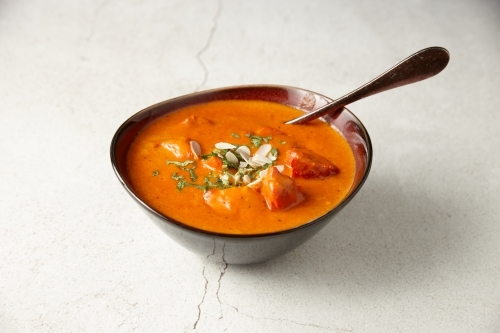 Butter chicken dish in bowl - Australian Stock Image