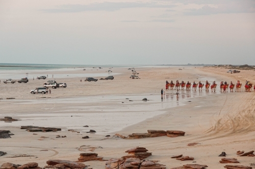 Cable beach Broome with camel rides and 4WD vehicles on the beach for sunset