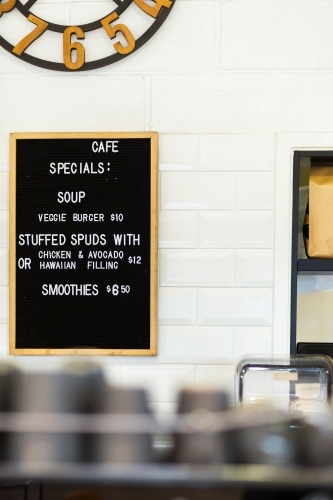 Café menu sign on wall showing specials