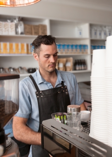 Cafe owner making coffee - Australian Stock Image