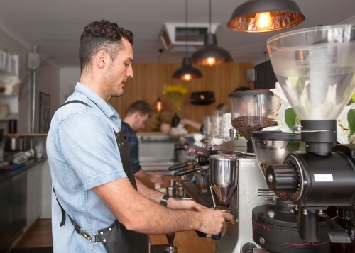 Cafe owner making coffee - Australian Stock Image