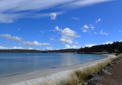 Calm bay with white sandy beach sunny day - Australian Stock Image