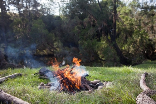 Campfire by a river - Australian Stock Image