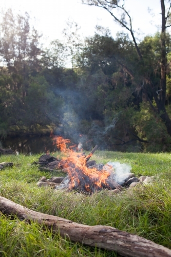 Campfire by a river - Australian Stock Image