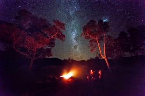 Camping and watching the campfire under stars