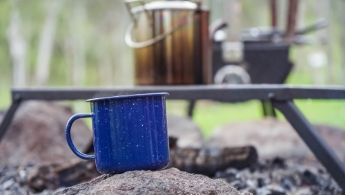 Camping coffee cup sitting on rock