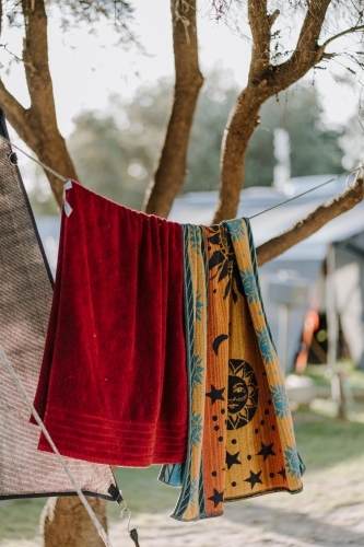 Camping towels hung on line in tree - Australian Stock Image