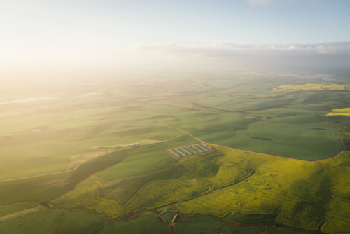 Canola and farming landscape over the Avon Valley in Western Australia at sunrise - Australian Stock Image