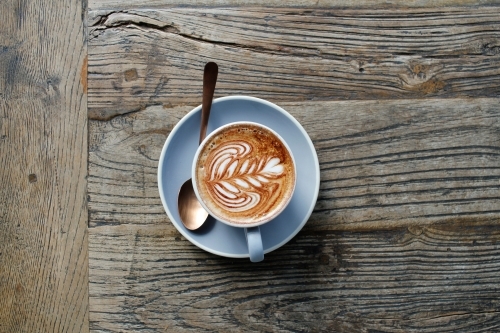 Cappuccino from above on a rustic wooden table with copy space