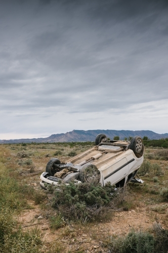 Car accident, a car rolled over after having an accident on a rural road - Australian Stock Image