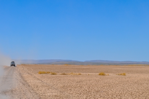 Car traveling on a dry gravel road - Australian Stock Image