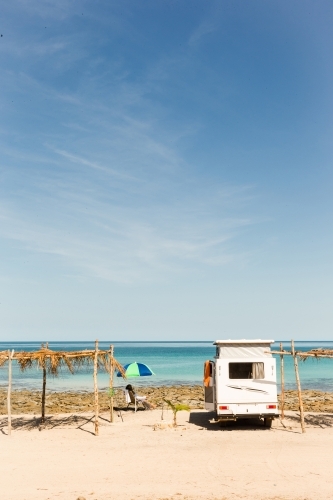 Caravan and shades against ocean horizon - Australian Stock Image