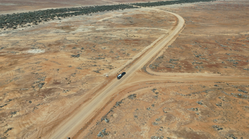 Caravan driving along dirt road in the outback - Australian Stock Image