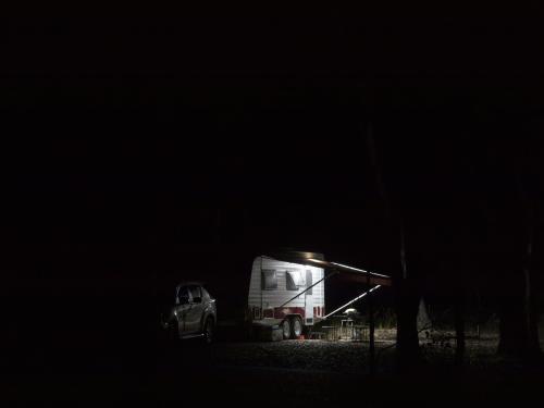 Caravan partially lit at night